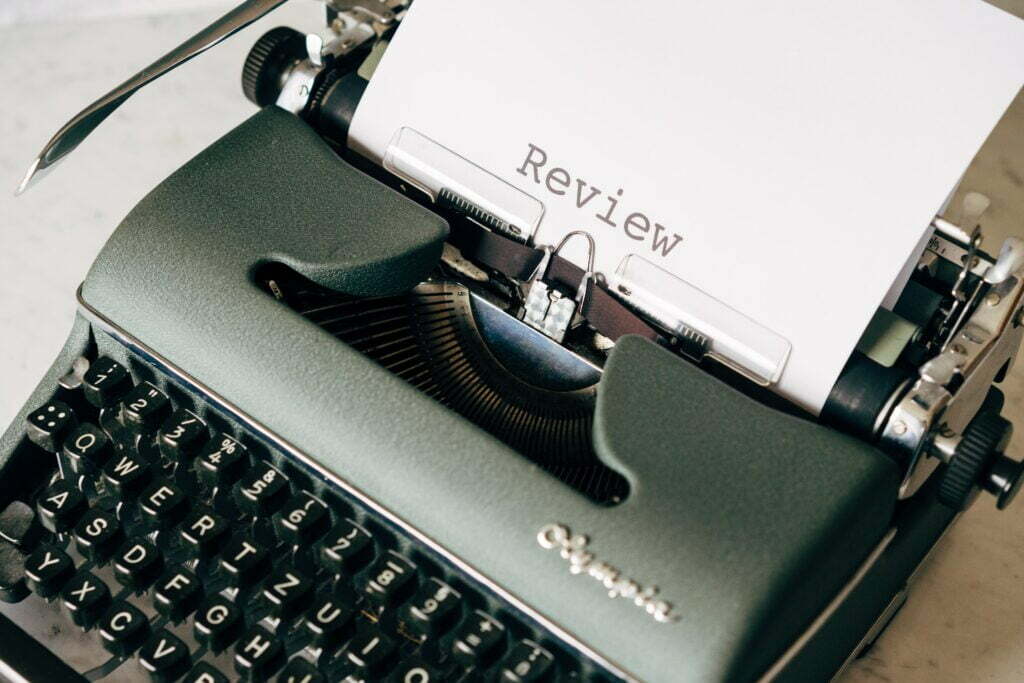 Typewriter printing out the word review