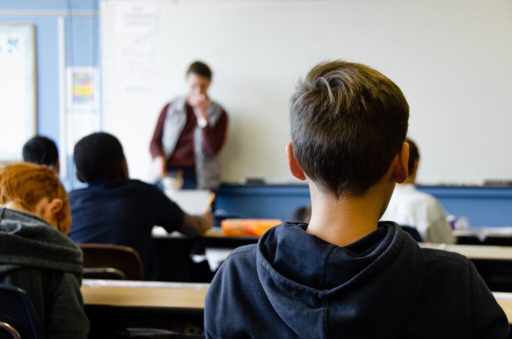 Students listening to their teacher in classroom