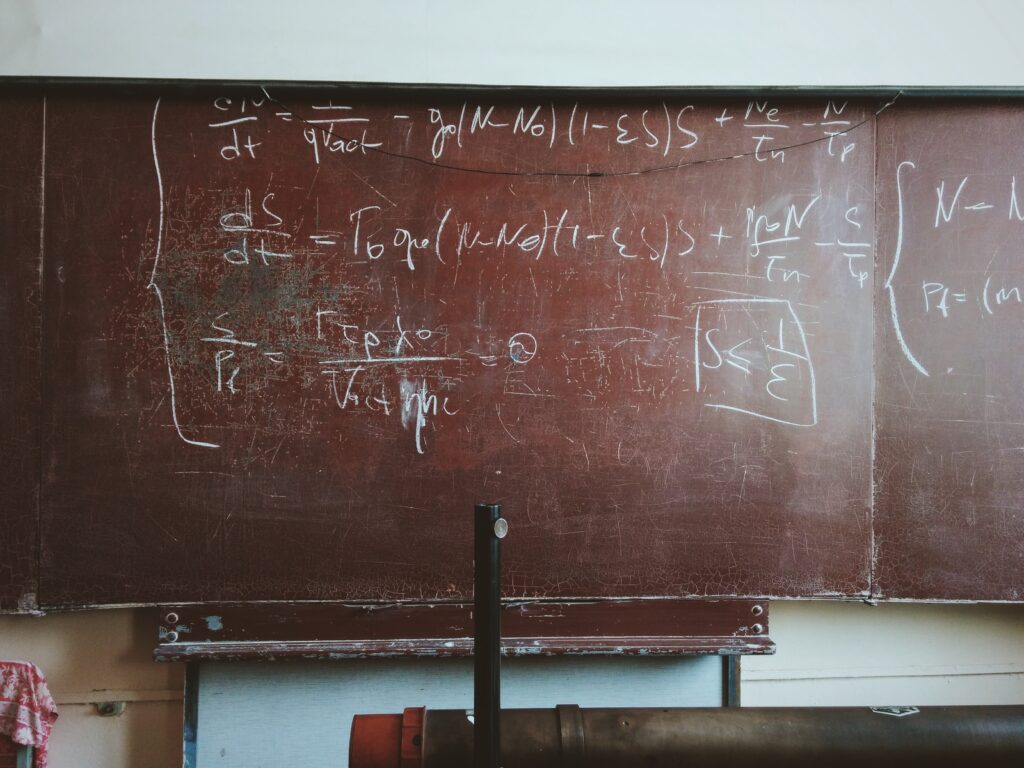 Blackboard in classroom with equations on it